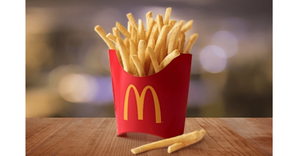 large box of mcdonald's fries standing up on a table 